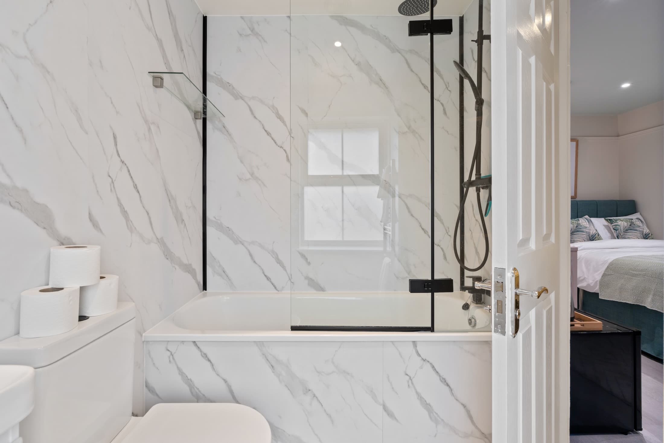 Bright bedroom with practical workspace and storage